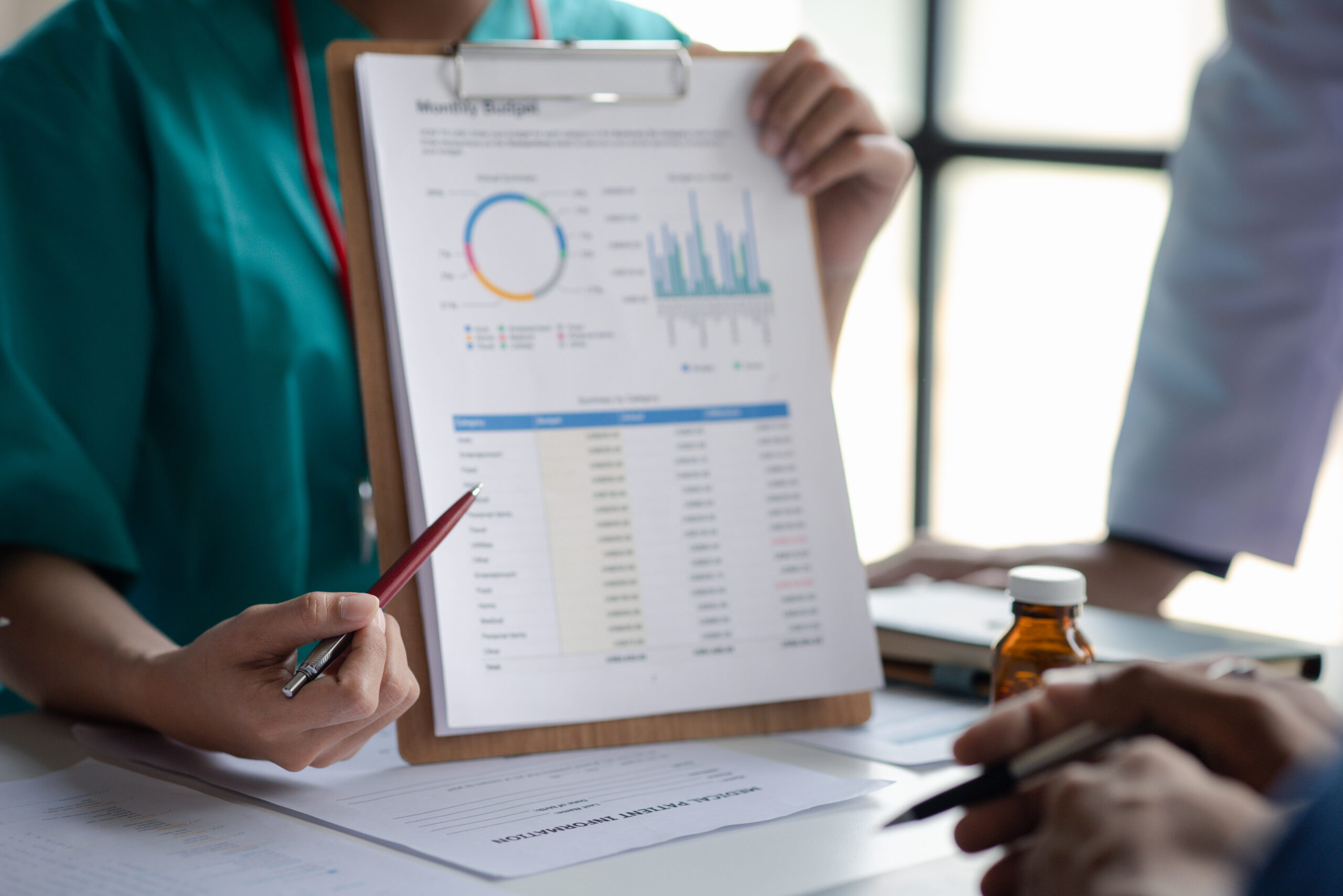 A conference room in a hospital where a group of doctors are att